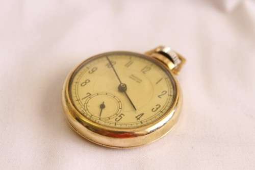 An awesome USA made Westclox Pocket Ben gold plated open-face pocket watch with a fob chain