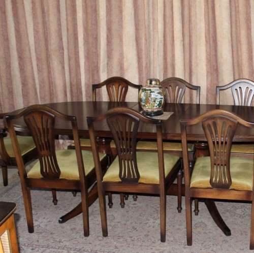 A beautiful solid Oak dining suite with a large extendible table and eight upholstered chairs.