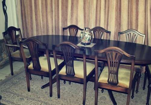 A beautiful solid Oak dining suite with a large extendible table and eight upholstered chairs.