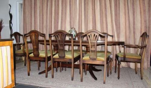 A beautiful solid Oak dining suite with a large extendible table and eight upholstered chairs.