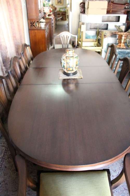 A beautiful solid Oak dining suite with a large extendible table and eight upholstered chairs.