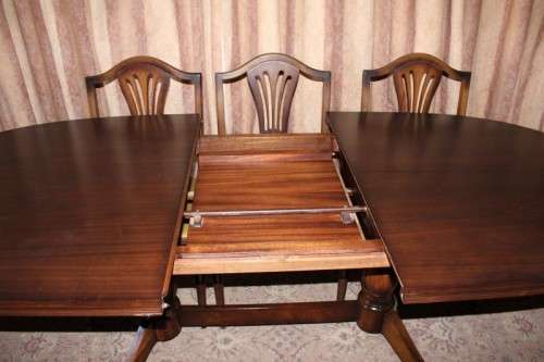A beautiful solid Oak dining suite with a large extendible table and eight upholstered chairs.