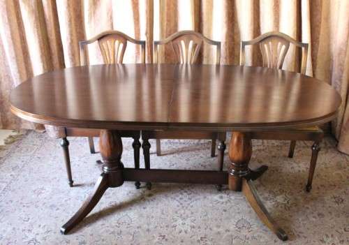 A beautiful solid Oak dining suite with a large extendible table and eight upholstered chairs.