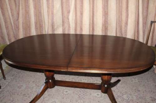 A beautiful solid Oak dining suite with a large extendible table and eight upholstered chairs.