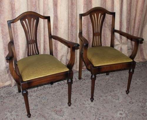 A beautiful solid Oak dining suite with a large extendible table and eight upholstered chairs.