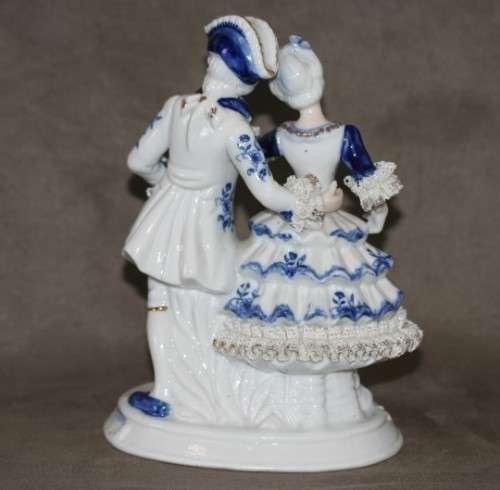 A beautiful blue and white porcelain figurine of a Victorian couple, fabulous on display.