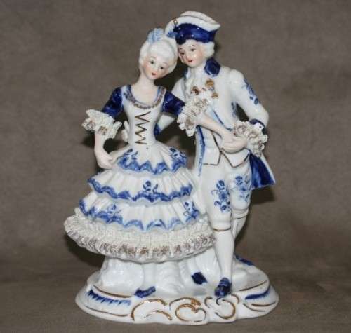 A beautiful blue and white porcelain figurine of a Victorian couple, fabulous on display.