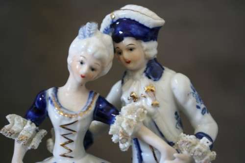 A beautiful blue and white porcelain figurine of a Victorian couple, fabulous on display.