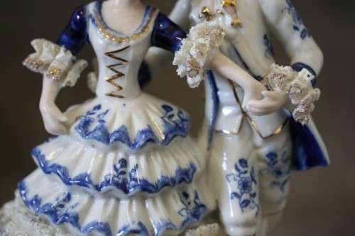 A beautiful blue and white porcelain figurine of a Victorian couple, fabulous on display.