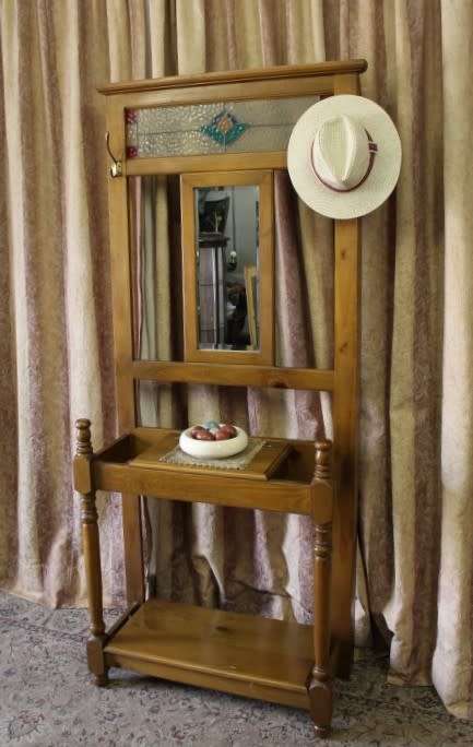 A gorgeous light wood hall stand with a coloured stained glass top, centre mirror and storage drawer