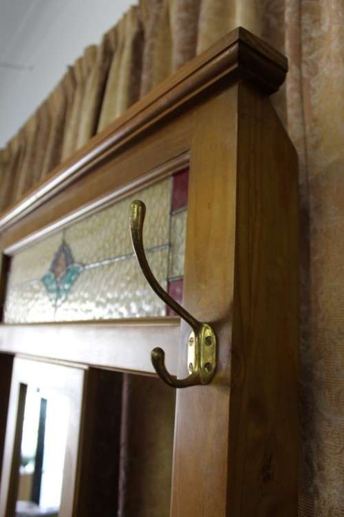 A gorgeous light wood hall stand with a coloured stained glass top, centre mirror and storage drawer