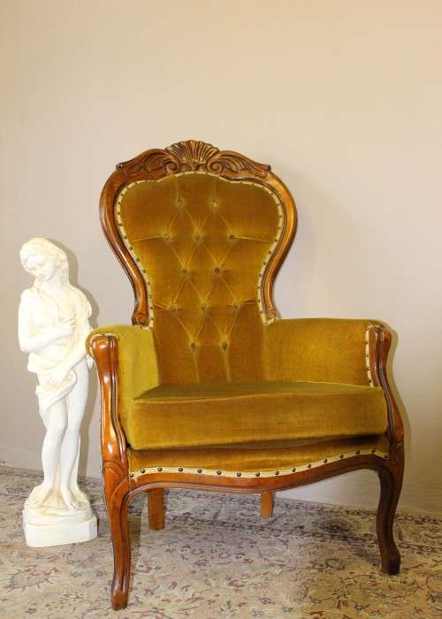 An elegant vintage Victorian styled carved arm chair w/ button detailing & gorgeous golden fabric.