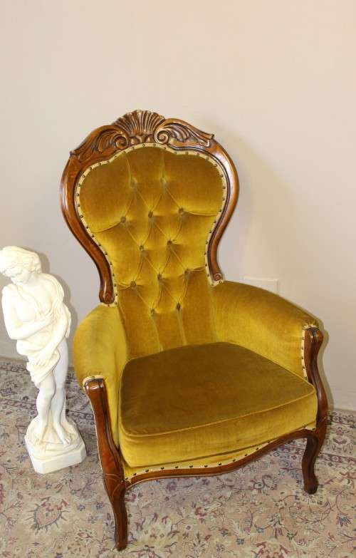 An elegant vintage Victorian styled carved arm chair w/ button detailing & gorgeous golden fabric.