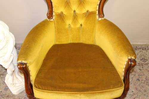 An elegant vintage Victorian styled carved arm chair w/ button detailing & gorgeous golden fabric.