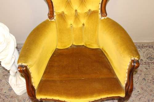 An elegant vintage Victorian styled carved arm chair w/ button detailing & gorgeous golden fabric.