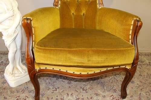 An elegant vintage Victorian styled carved arm chair w/ button detailing & gorgeous golden fabric.