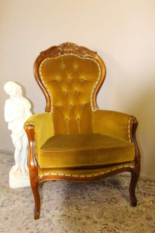 An elegant vintage Victorian styled carved arm chair w/ button detailing & gorgeous golden fabric.
