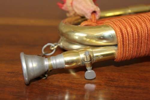 A fantastic ornate vintage brass military bugle with orange rope & tassel. Lifespace Sale