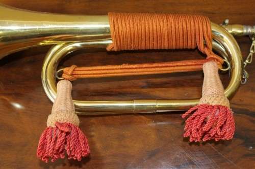A fantastic ornate vintage brass military bugle with orange rope & tassel. Lifespace Sale