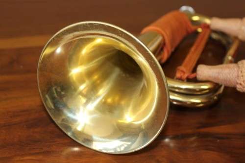 A fantastic ornate vintage brass military bugle with orange rope & tassel. Lifespace Sale