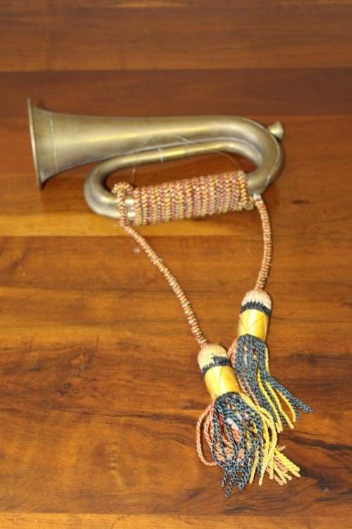 A fabulous vintage brass military bugle with colourful rope & tassel.  Lifespace Sale
