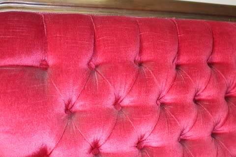 A gorgeous antique Victorian 3 seater settee couch w carved detailing and period style upholstery.