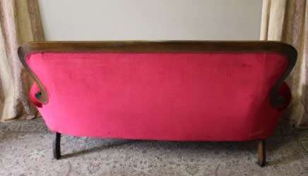 A gorgeous antique Victorian 3 seater settee couch w carved detailing and period style upholstery.
