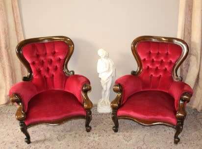 An elegant pair of antique Victorian styled arm chairs w/ button detailing & gorgeous fabric.