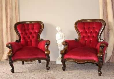 An elegant pair of antique Victorian styled arm chairs w/ button detailing & gorgeous fabric.