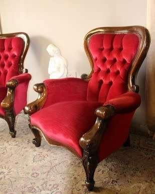 An elegant pair of antique Victorian styled arm chairs w/ button detailing & gorgeous fabric.