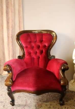An elegant pair of antique Victorian styled arm chairs w/ button detailing & gorgeous fabric.