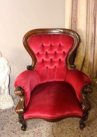 An elegant pair of antique Victorian styled arm chairs w/ button detailing & gorgeous fabric.