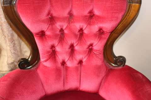 An elegant pair of antique Victorian styled arm chairs w/ button detailing & gorgeous fabric.