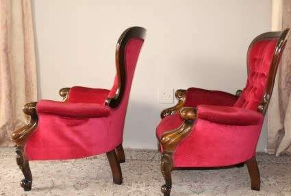 An elegant pair of antique Victorian styled arm chairs w/ button detailing & gorgeous fabric.