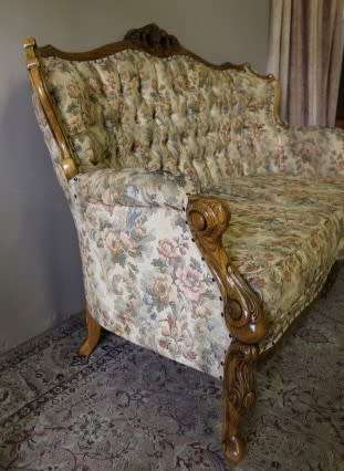 An exquisite Victorian 2 seater couch w carved detailing & period style floral upholstery. Beautiful
