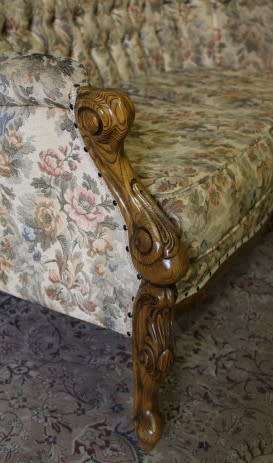An exquisite Victorian 2 seater couch w carved detailing & period style floral upholstery. Beautiful