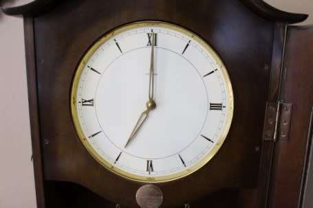 An exquisite Art Deco 1950's German made Junghans weight driven "Granddaughter" clock w/ enamel face