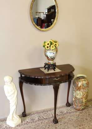 A beautiful vintage Imbuia scalloped edge Ball & claw half moon display/occasional table w/ a drawer