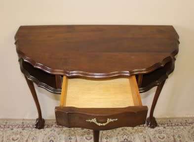 A beautiful vintage Imbuia scalloped edge Ball & claw half moon display/occasional table w/ a drawer