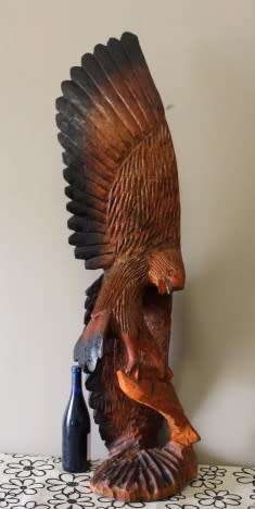 An exquisite, tall hand carved, detailed free standing wood eagle. Stunning feature display piece!