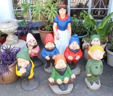 A fantastic concrete garden set of Snow white and the seven dwarfs, cheerful, colourful and bright.