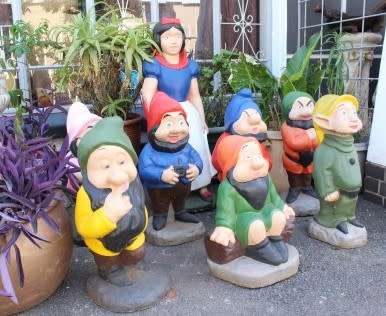 A fantastic concrete garden set of Snow white and the seven dwarfs, cheerful, colourful and bright.