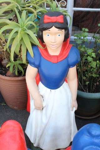 A fantastic concrete garden set of Snow white and the seven dwarfs, cheerful, colourful and bright.