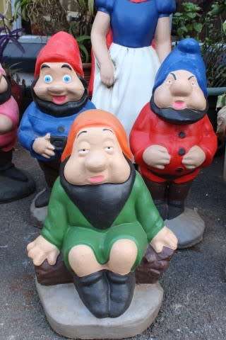 A fantastic concrete garden set of Snow white and the seven dwarfs, cheerful, colourful and bright.