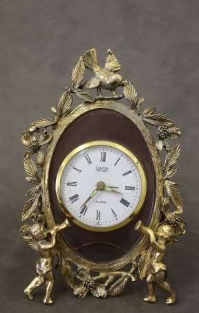 A beautiful vintage Japanese brass "Landex" wind up alarm clock with cherubs, working.