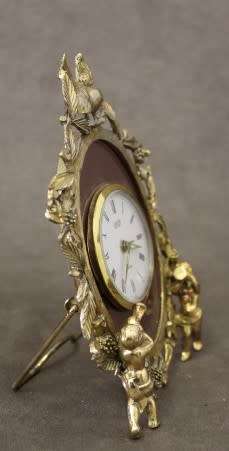 A beautiful vintage Japanese brass "Landex" wind up alarm clock with cherubs, working.
