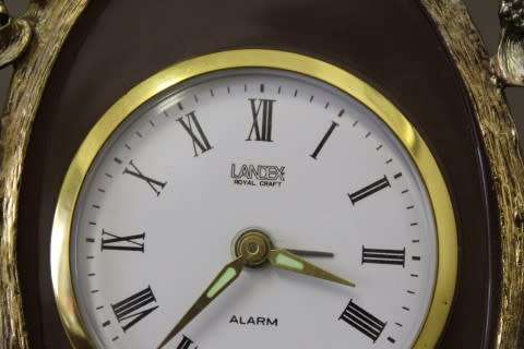 A beautiful vintage Japanese brass "Landex" wind up alarm clock with cherubs, working.