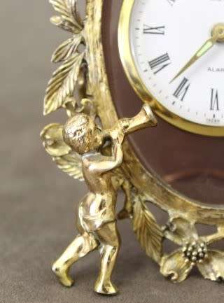 A beautiful vintage Japanese brass "Landex" wind up alarm clock with cherubs, working.