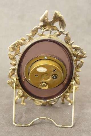A beautiful vintage Japanese brass "Landex" wind up alarm clock with cherubs, working.