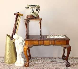 A gorgeous Imbuia ball and claw telephone table with riempies and storage under the seat.